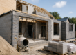 Partially completed home extension under construction in Newton Abbot showing brickwork, roof structure and building materials on site.