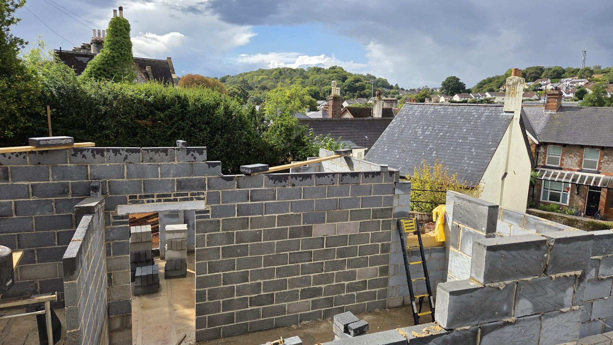 Budget for a building project in Devon showing architectural plans, construction site and cost planning by Edleigh Construction.