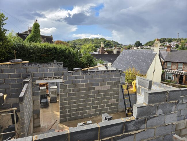 Budget for a building project in Devon showing architectural plans, construction site and cost planning by Edleigh Construction.