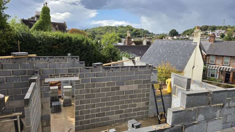 Budget for a building project in Devon showing architectural plans, construction site and cost planning by Edleigh Construction.